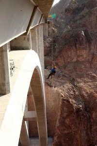 Brave inspector Trask Bradbury hangs out over the Mike O'Callaghan-Pat Tillman Memorial Bridge (Hoover Dam Bypass) during a routine biennial bridge inspection. The concrete-steel composite arch bridge looms 840 feet above the Colorado River and is the 2nd largest bridge in the United States at 1,900 feet in length.